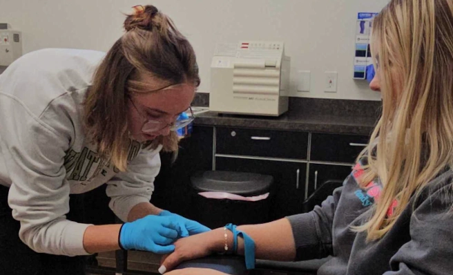 student training to apply an IV to a patient student training to apply an IV to a patient